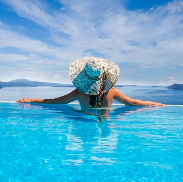 Woman in Grecian infinity pool