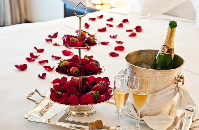 Strawberries and champagne with rose petals